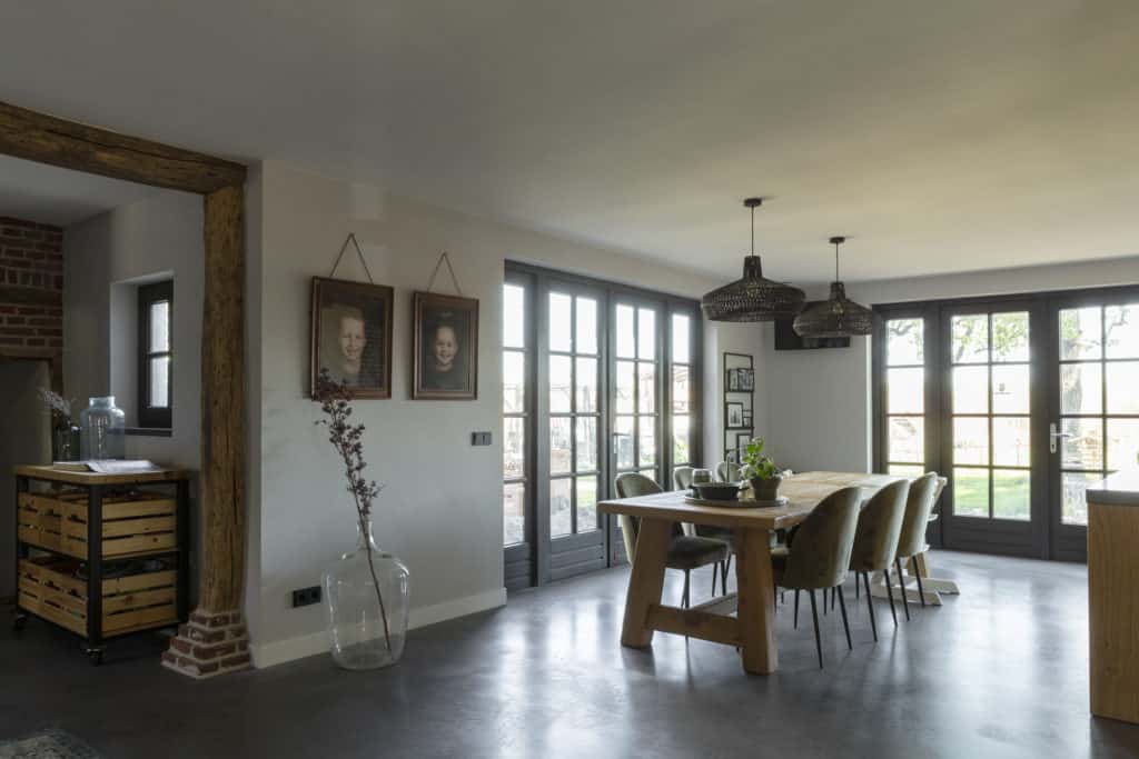 Een eetkamer met een gevlinderde betonvloer, designbetonvloer